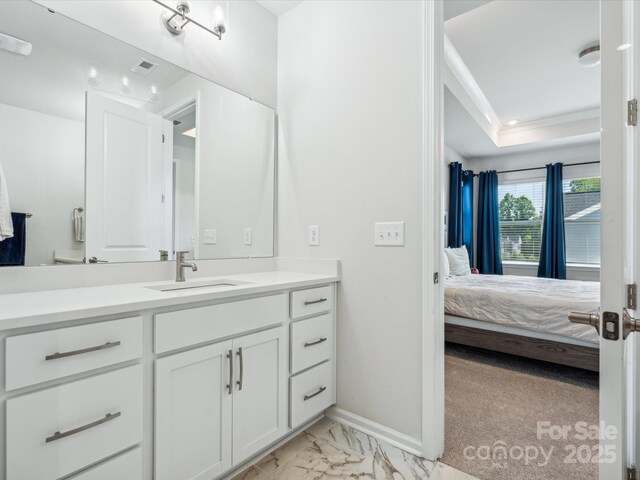 bathroom featuring visible vents, vanity, marble finish floor, ensuite bathroom, and baseboards