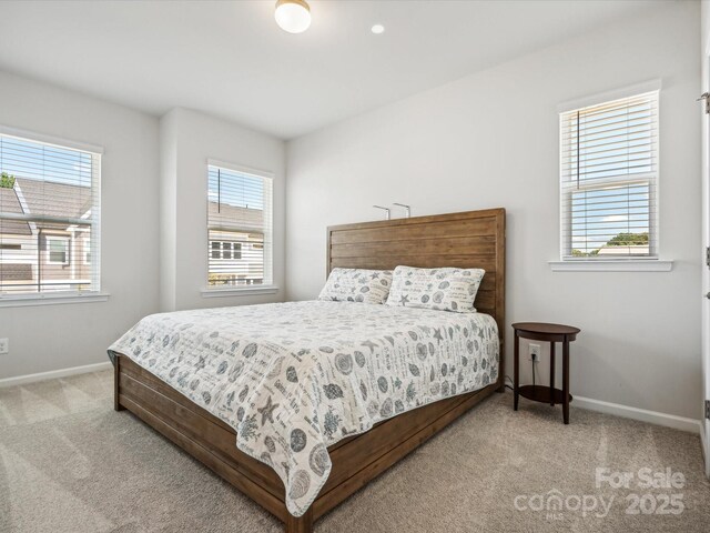 carpeted bedroom featuring baseboards