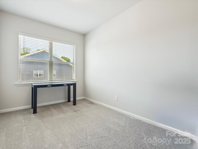 unfurnished office with carpet floors and baseboards