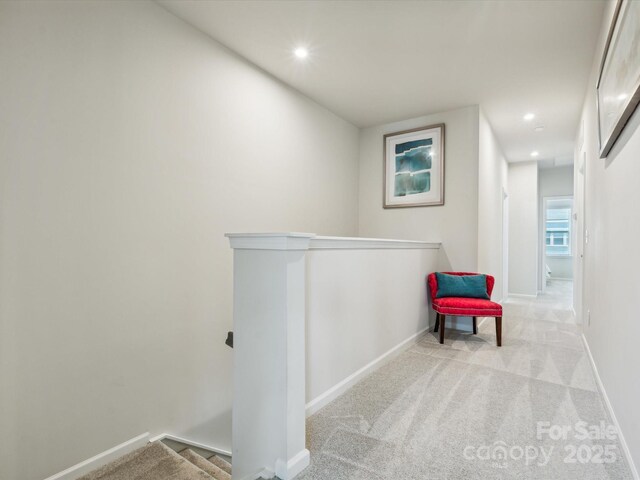 corridor featuring carpet floors, baseboards, and recessed lighting