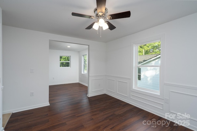 1411 Caldwell St, Gastonia, NC 28052 - spare room featuring dark wood-type flooring, a ceiling fan, and plenty of natural light