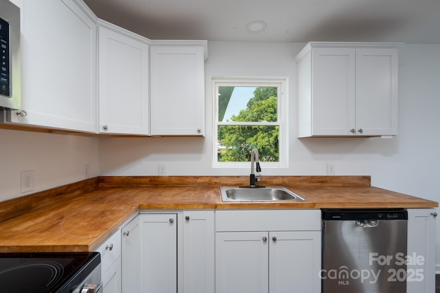 1411 Caldwell St, Gastonia, NC 28052 - kitchen with a sink, white cabinetry, butcher block counters, and stainless steel appliances