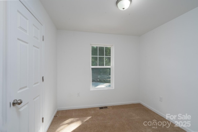 1411 Caldwell St, Gastonia, NC 28052 - carpeted spare room featuring visible vents and baseboards
