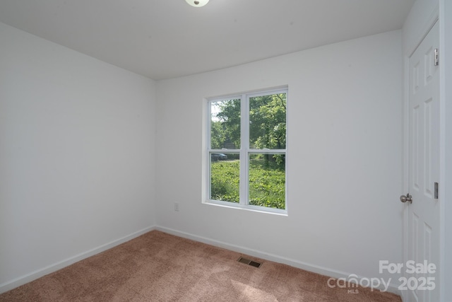 1411 Caldwell St, Gastonia, NC 28052 - carpeted spare room with baseboards and visible vents