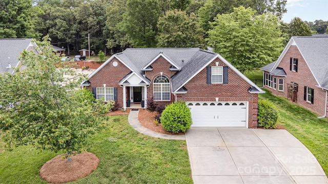 traditional-style house with brick siding, concrete driveway, and a front yard