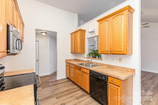 kitchen featuring black dishwasher, stainless steel microwave, a sink, range with electric cooktop, and light wood-style floors