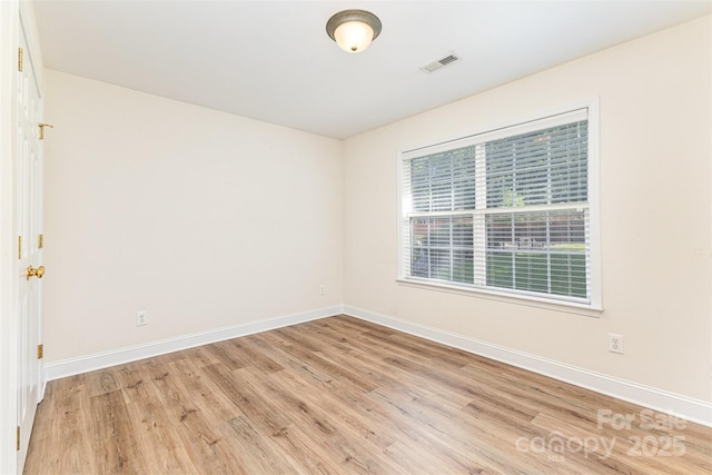 unfurnished room featuring light wood-type flooring and baseboards