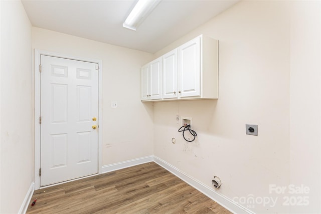 washroom with hookup for a gas dryer, electric dryer hookup, cabinet space, hookup for a washing machine, and light wood-type flooring