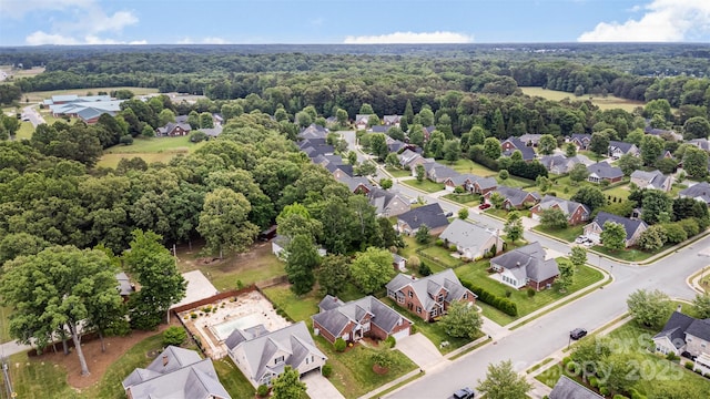 aerial view of residential area with a heavily wooded area