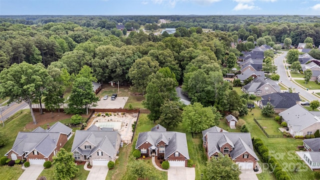 aerial view of residential area with a heavily wooded area
