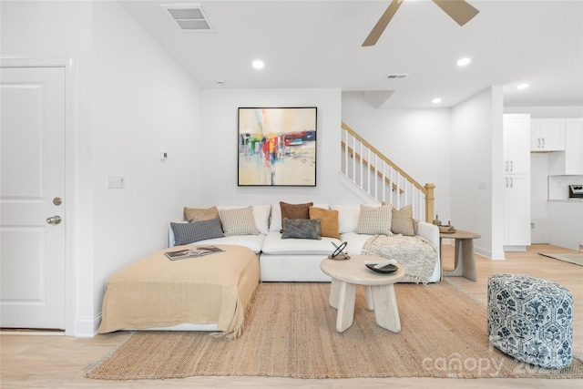 living area featuring light wood-type flooring, a ceiling fan, visible vents, and recessed lighting
