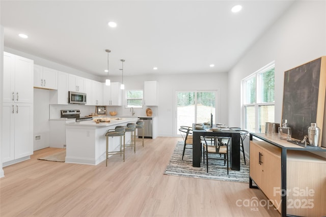 kitchen featuring appliances with stainless steel finishes, light wood-type flooring, and recessed lighting