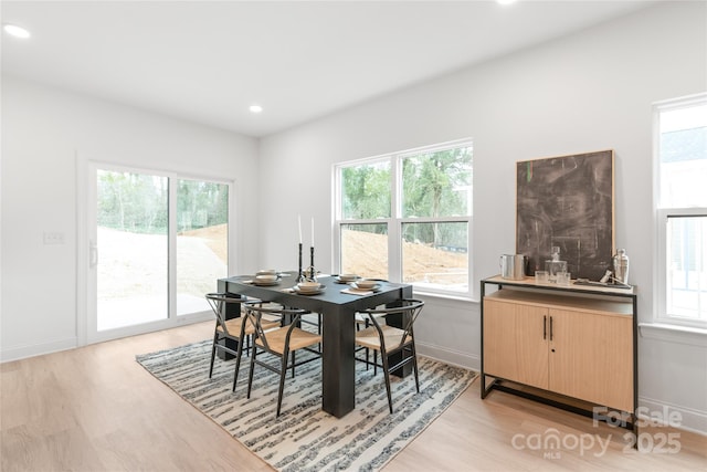 dining space featuring recessed lighting, baseboards, and light wood-type flooring
