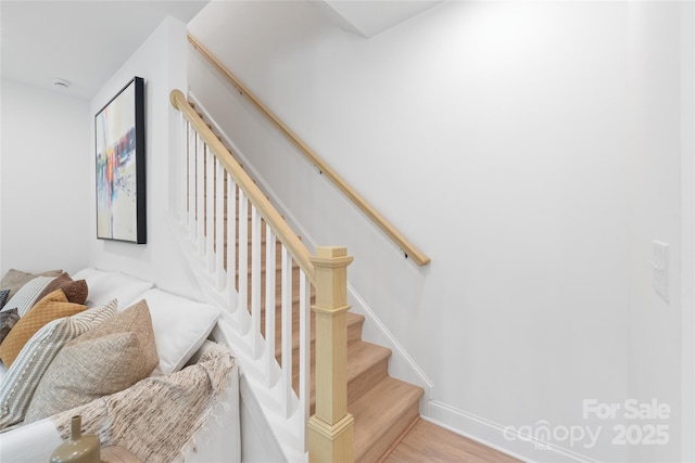 stairway with baseboards and wood finished floors