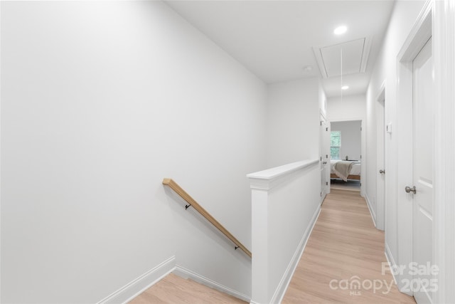 corridor featuring attic access, baseboards, an upstairs landing, recessed lighting, and light wood-style flooring