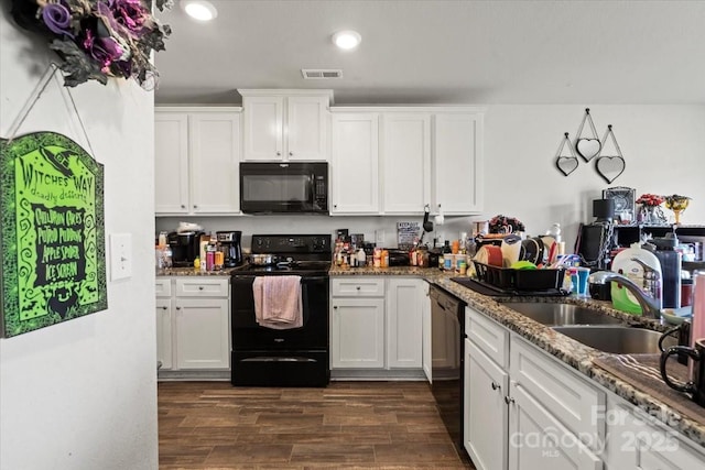 1270 Winding Creek Rd, Salisbury, NC 28146 - kitchen featuring black appliances, white cabinetry, recessed lighting, dark wood-type flooring, and light stone counters