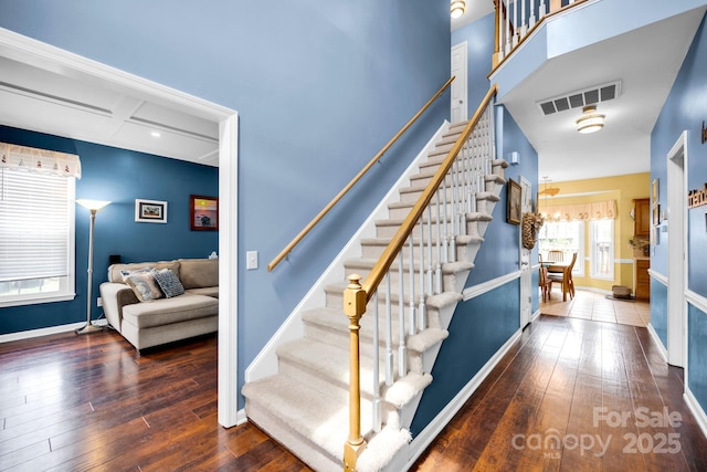 stairway featuring hardwood / wood-style floors and baseboards