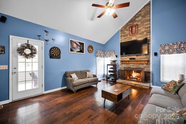 living room with a ceiling fan, a fireplace, wood finished floors, high vaulted ceiling, and baseboards