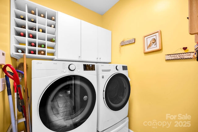 clothes washing area with cabinet space and separate washer and dryer
