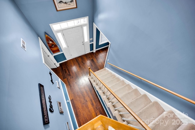entryway featuring stairway, baseboards, and hardwood / wood-style flooring
