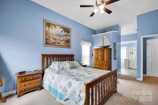 carpeted bedroom with baseboards, ceiling fan, and ensuite bathroom