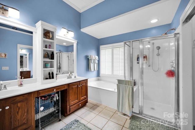 bathroom featuring a shower stall, a bath, double vanity, tile patterned floors, and crown molding