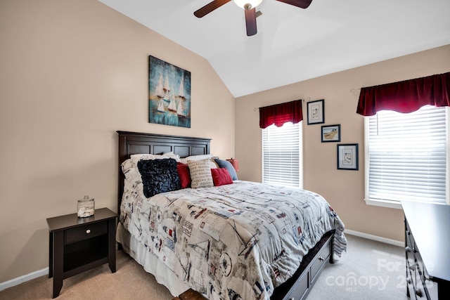 bedroom featuring light carpet, lofted ceiling, baseboards, and ceiling fan
