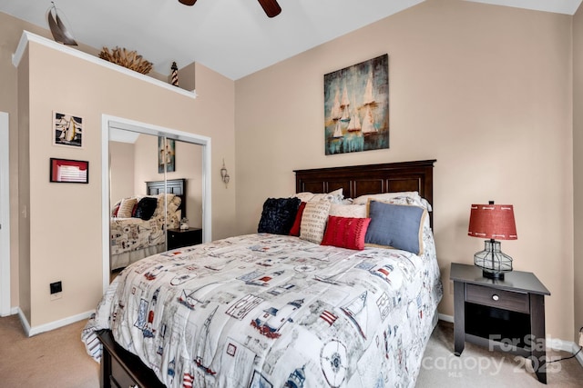 bedroom featuring light colored carpet, baseboards, a closet, and a ceiling fan