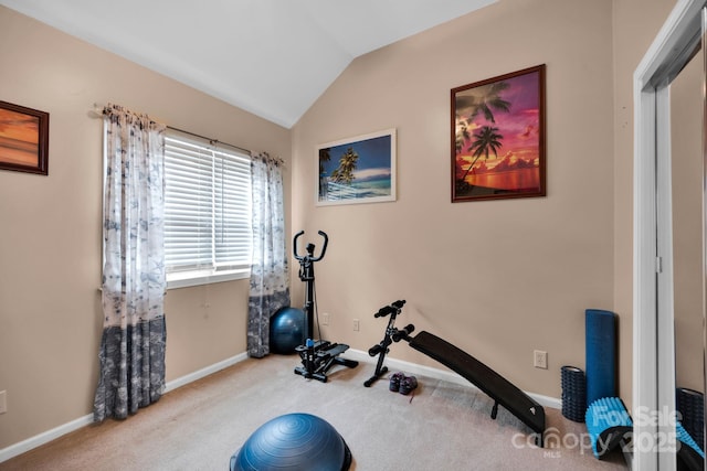 workout room featuring carpet flooring, vaulted ceiling, and baseboards