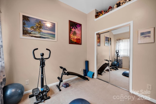exercise room with carpet floors and baseboards