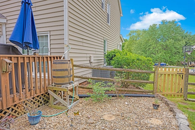 view of side of property featuring fence and a wooden deck