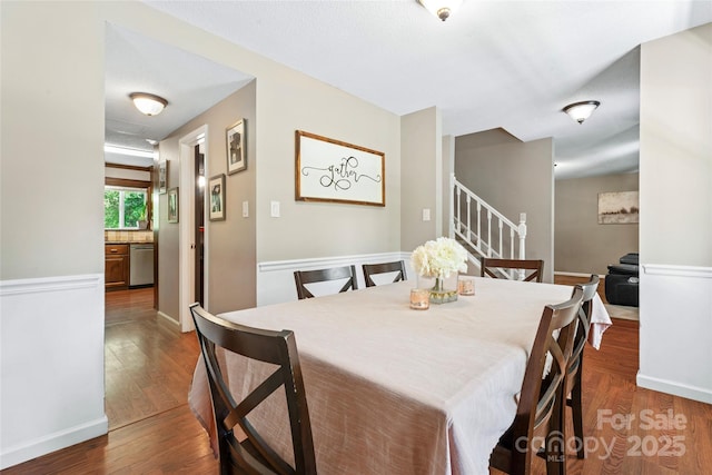 dining area featuring stairway and wood finished floors
