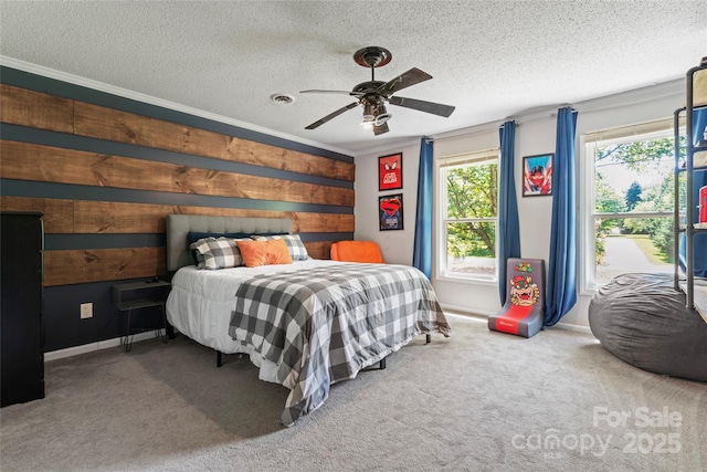 carpeted bedroom with baseboards, wood walls, a textured ceiling, and ceiling fan
