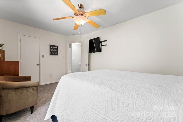 carpeted bedroom featuring baseboards and ceiling fan