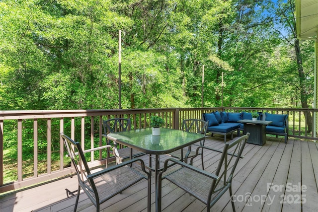 deck with outdoor dining area and outdoor lounge area