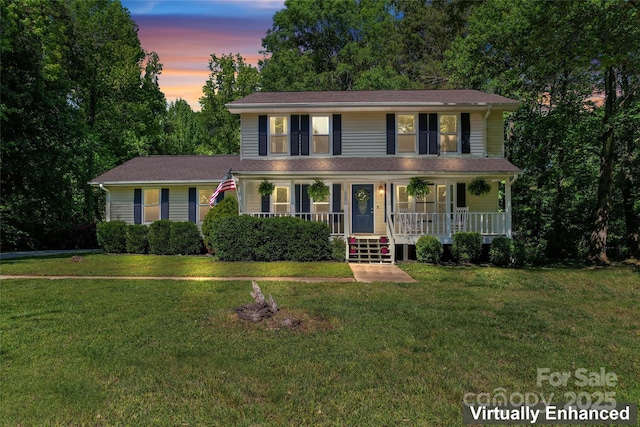 colonial house with covered porch and a front yard