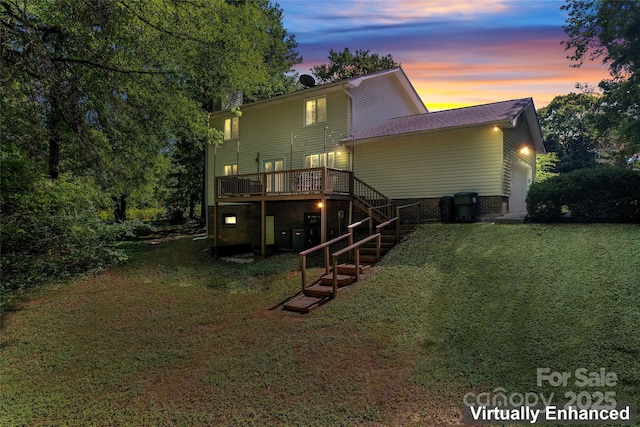 back of property at dusk featuring a lawn, stairs, a deck, and a garage