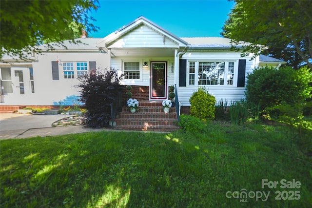 bungalow-style house with a front yard