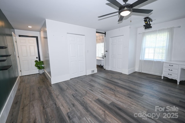 unfurnished bedroom with baseboards, ceiling fan, and dark wood finished floors