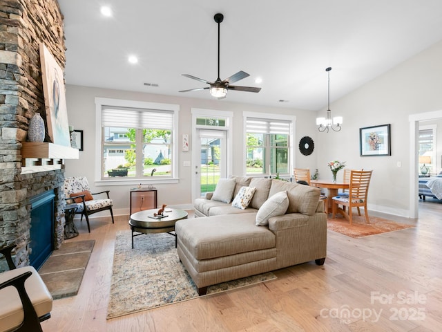 living room featuring a fireplace, light wood-style floors, baseboards, healthy amount of natural light, and recessed lighting
