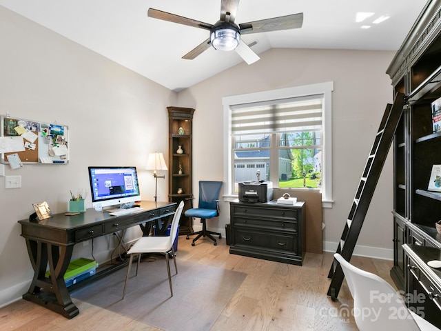 home office featuring light wood finished floors, a ceiling fan, lofted ceiling, and baseboards