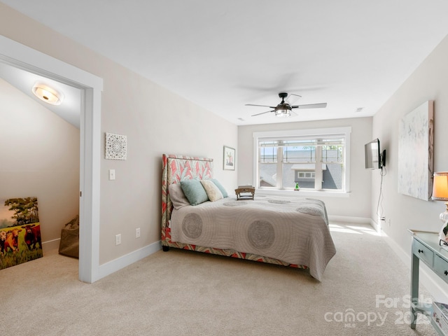 carpeted bedroom with baseboards and a ceiling fan