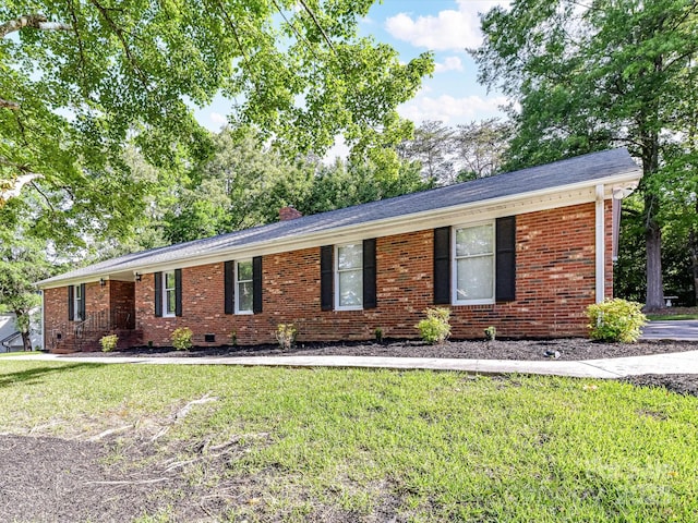 single story home with a front yard, brick siding, and a chimney