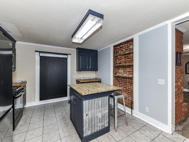 kitchen featuring black gas range oven, light tile patterned flooring, a textured ceiling, crown molding, and brick wall