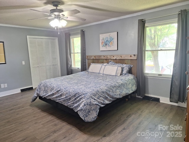 70 Cumberland Ct SW, Concord, NC 28025 - bedroom featuring wood finished floors, a closet, multiple windows, crown molding, and baseboards
