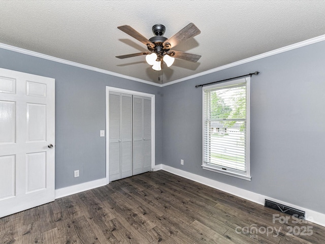 70 Cumberland Ct SW, Concord, NC 28025 - unfurnished bedroom featuring a closet, ornamental molding, dark wood finished floors, baseboards, and a ceiling fan
