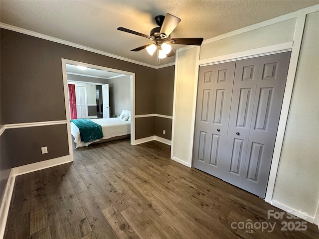 70 Cumberland Ct SW, Concord, NC 28025 - bedroom featuring crown molding, dark wood-type flooring, baseboards, a textured ceiling, and a closet