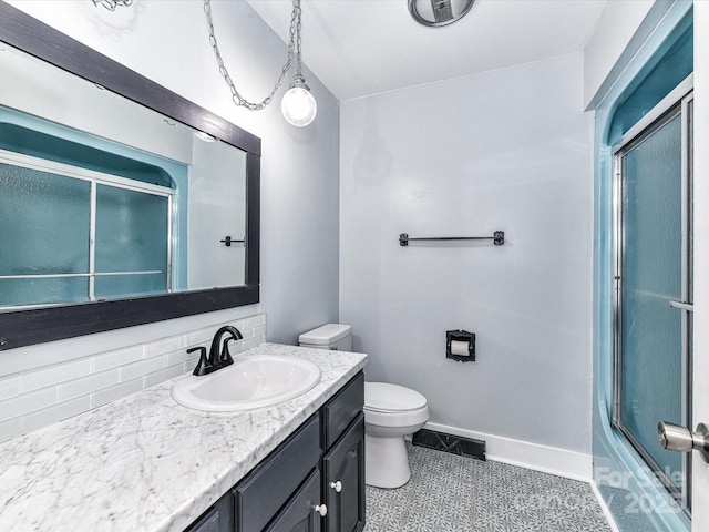 70 Cumberland Ct SW, Concord, NC 28025 - full bathroom featuring vanity, toilet, baseboards, and combined bath / shower with glass door