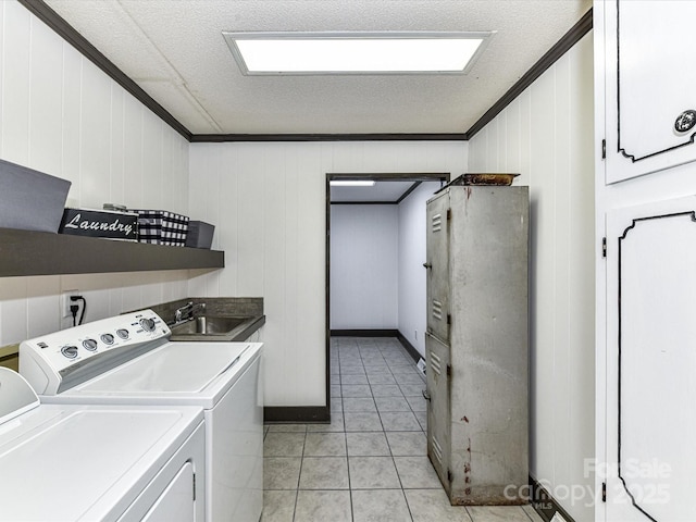 70 Cumberland Ct SW, Concord, NC 28025 - washroom featuring washer and dryer, ornamental molding, cabinet space, light tile patterned floors, and a textured ceiling