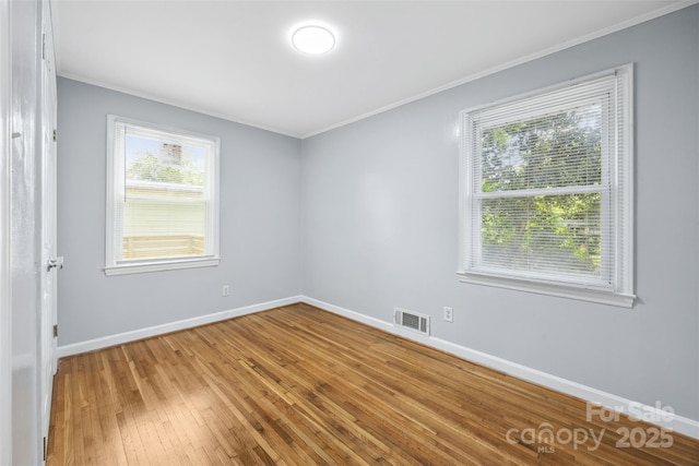 3828 Delgany Dr, Charlotte, NC 28215 - spare room with crown molding, baseboards, and light wood finished floors